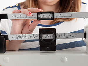 Example of woman measuring her body weight